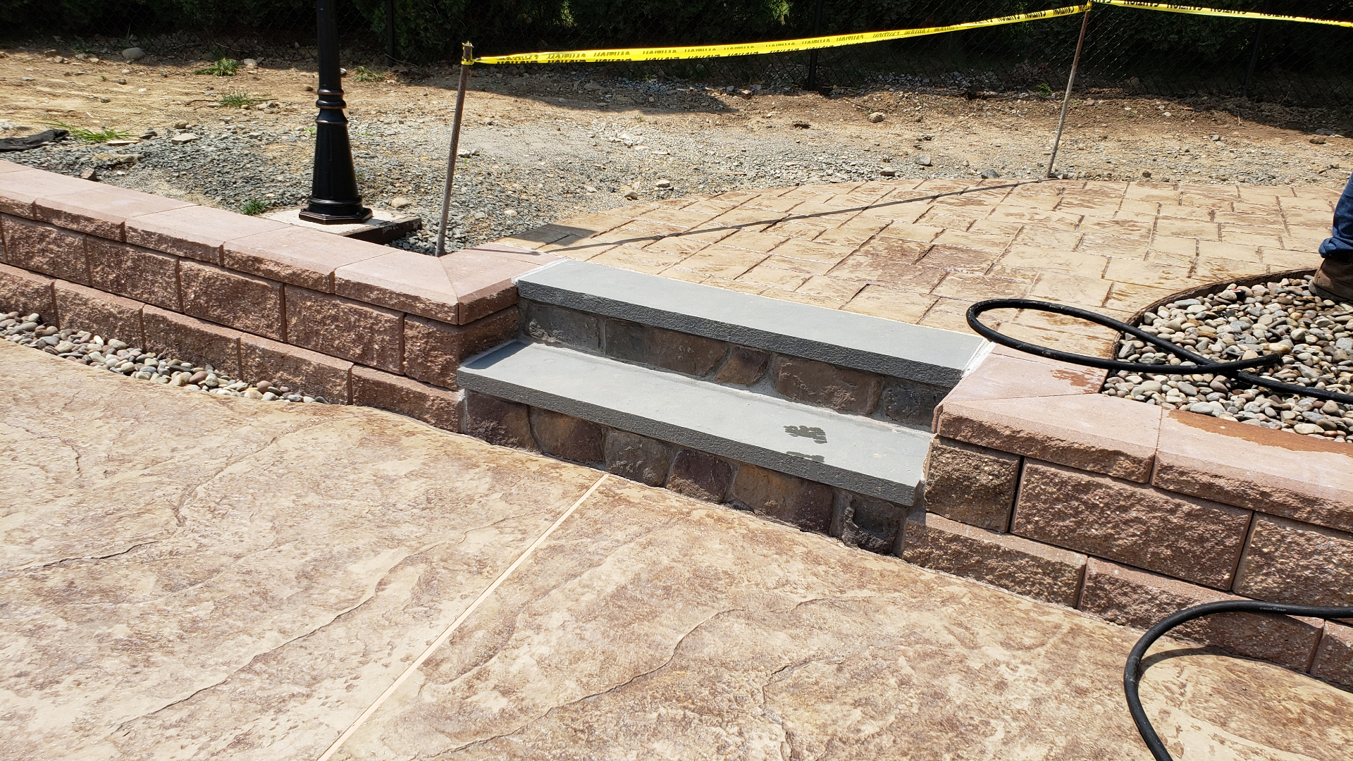 Stamped patio with bluestone-capped block steps