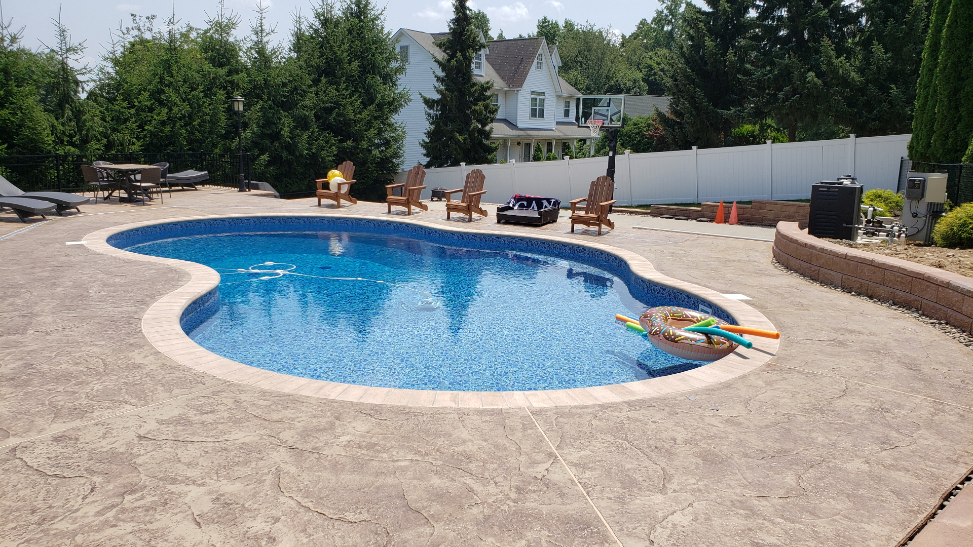 Kidney-shaped pool with stamped concrete deck