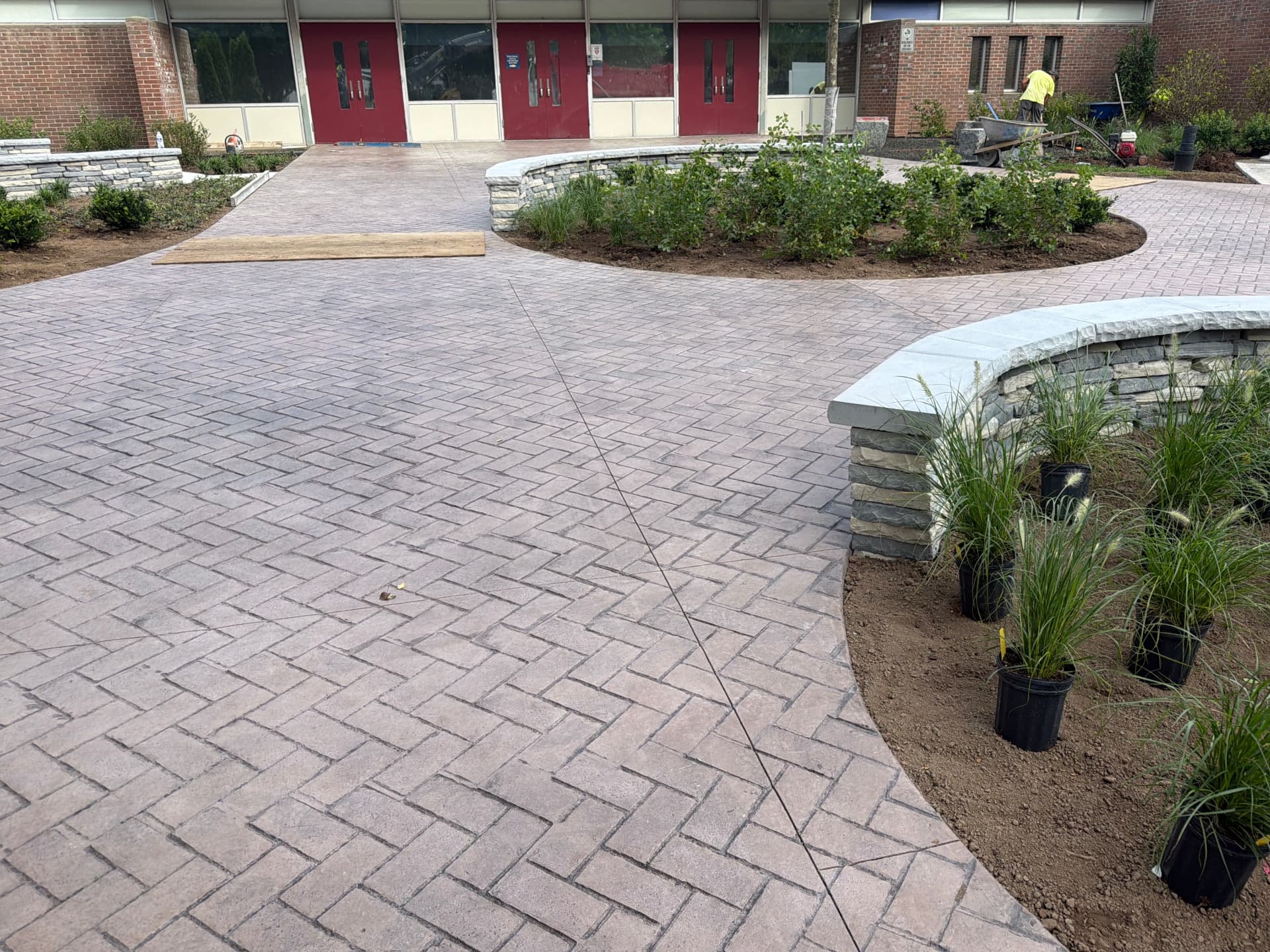 Herringbone brick stamped courtyard with stone seat walls